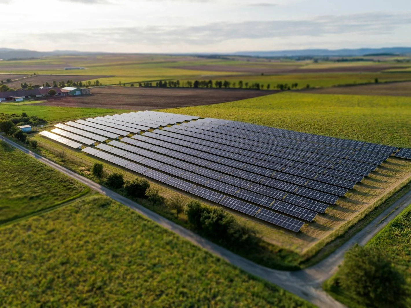 Aerial view of a solar panel farm representing renewable energy investment opportunity